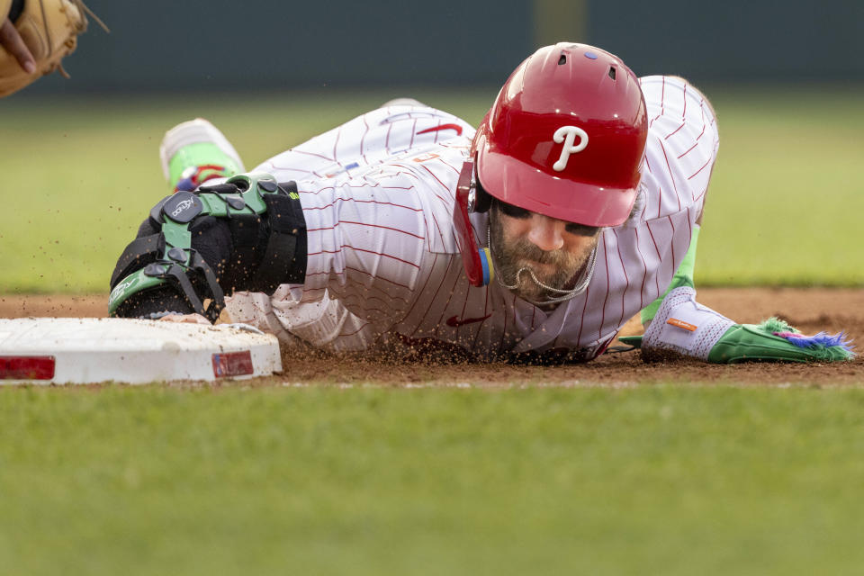 Philadelphia Phillies' Bryce Harper is safe on a pickoff attempt at first base during the fourth inning of the team's baseball game against the Washington Nationals, Friday, June 30, 2023, in Philadelphia. (AP Photo/Laurence Kesterson)