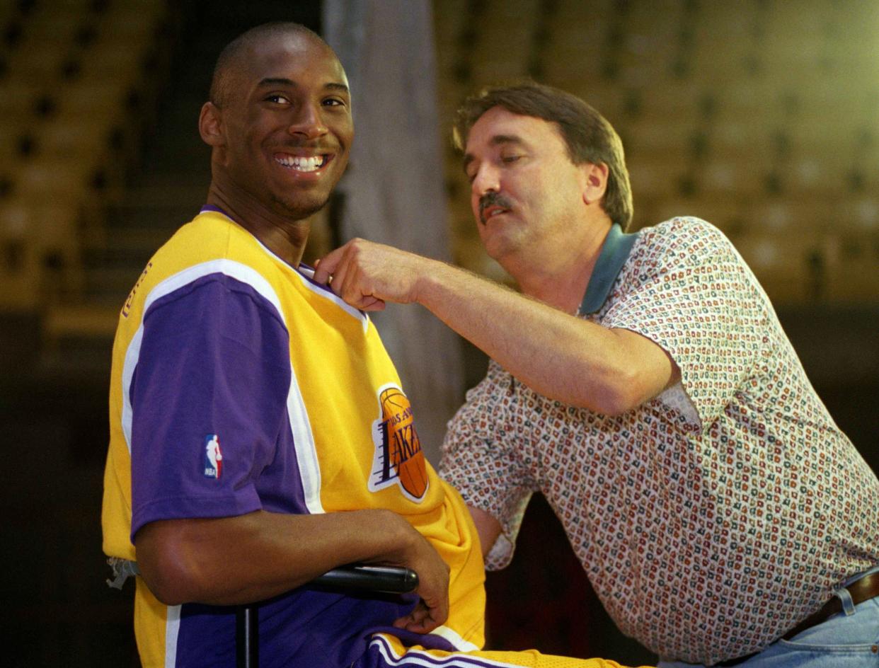 Los Angeles Lakers rookie Kobe Bryant is heckled by teammates as a television cameraman adjusts a microphone on his jersey for an interviewed during the Lakers? Media Day at the Forum in Inglewood, California on Monday, Oct. 14, 1996.