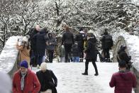 People enjoy Central Park after a snowstorm Tuesday, Feb. 13, 2024, in New York. (AP Photo/Frank Franklin II)