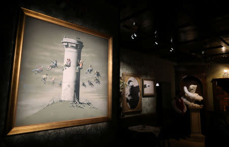 Works by street artist Banksy are displayed in the Walled Off hotel, which was opened by in the West Bank city of Bethlehem March 3, 2017. REUTERS/Ammar Awad