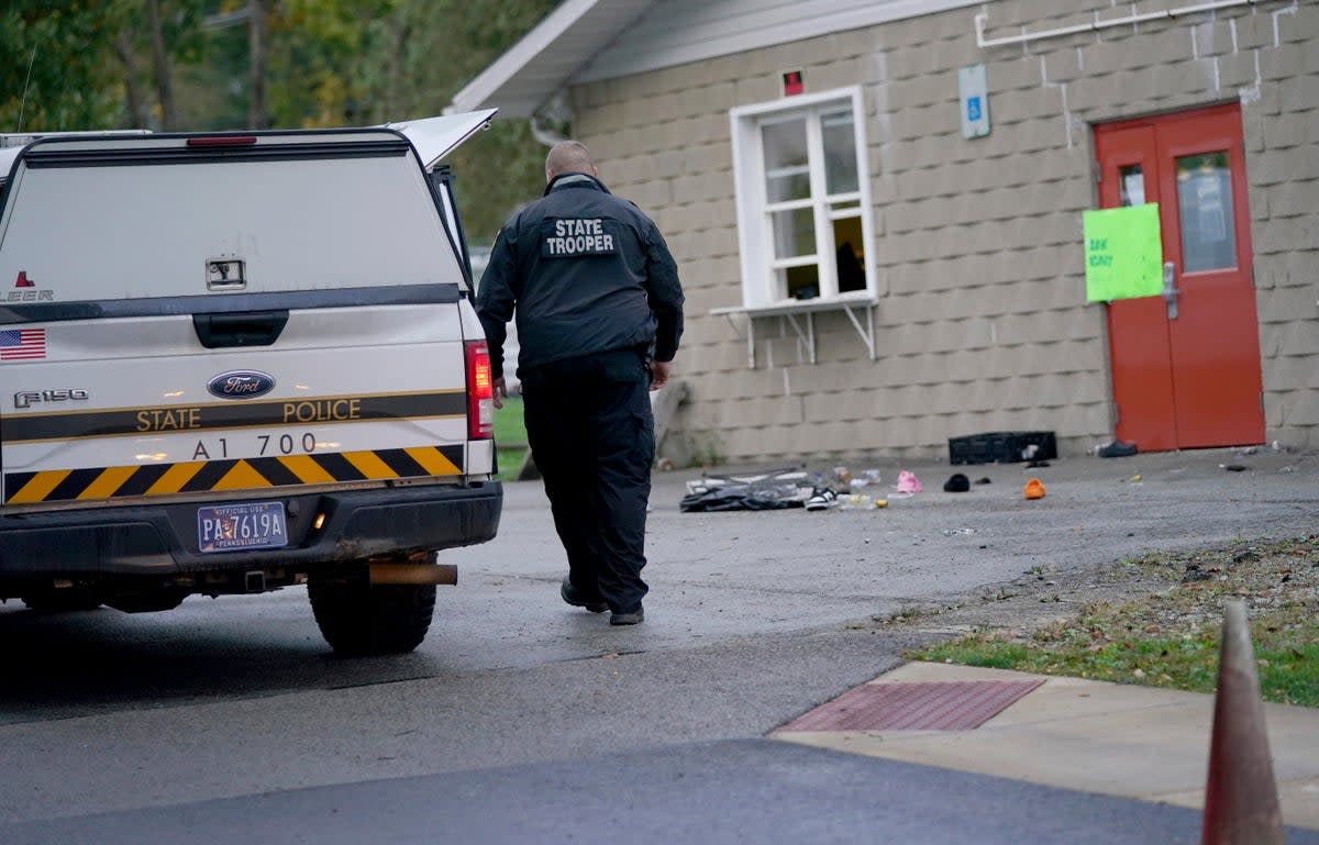 FILE: A trooper from the Pennsylvania State Police Reconstruction Unit works at the crime scene of a fatal shooting at the Chevy Chase Community Center. An Indian student died days after being stabbed in the head while working out at a fitness centre near his university in Indiana (ASSOCIATED PRESS)