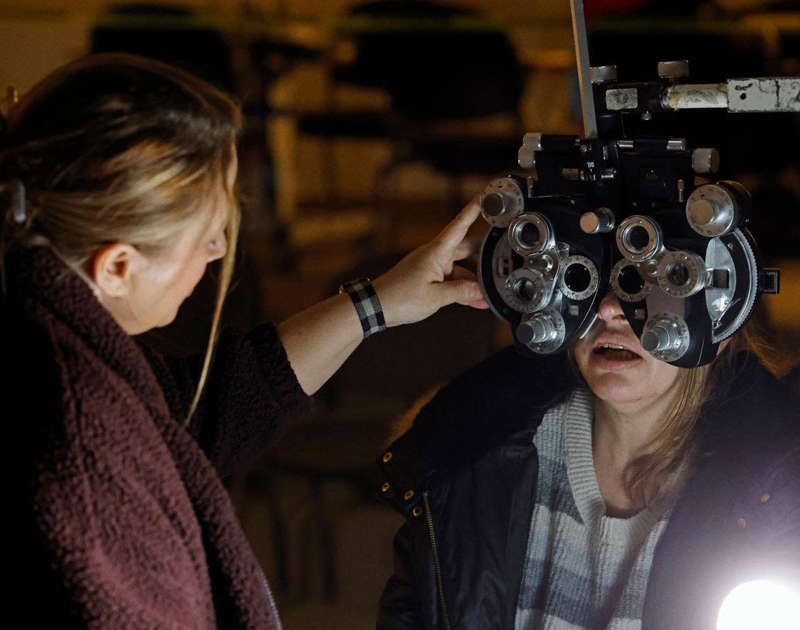 Certified Ophthalmic Assistant Jennifer Garland does a routine eye exam for Sherri Hellige at the Remote Area Medical Clinic at the Southwestern Baptist Theological Seminary in Fort Worth on Saturday.