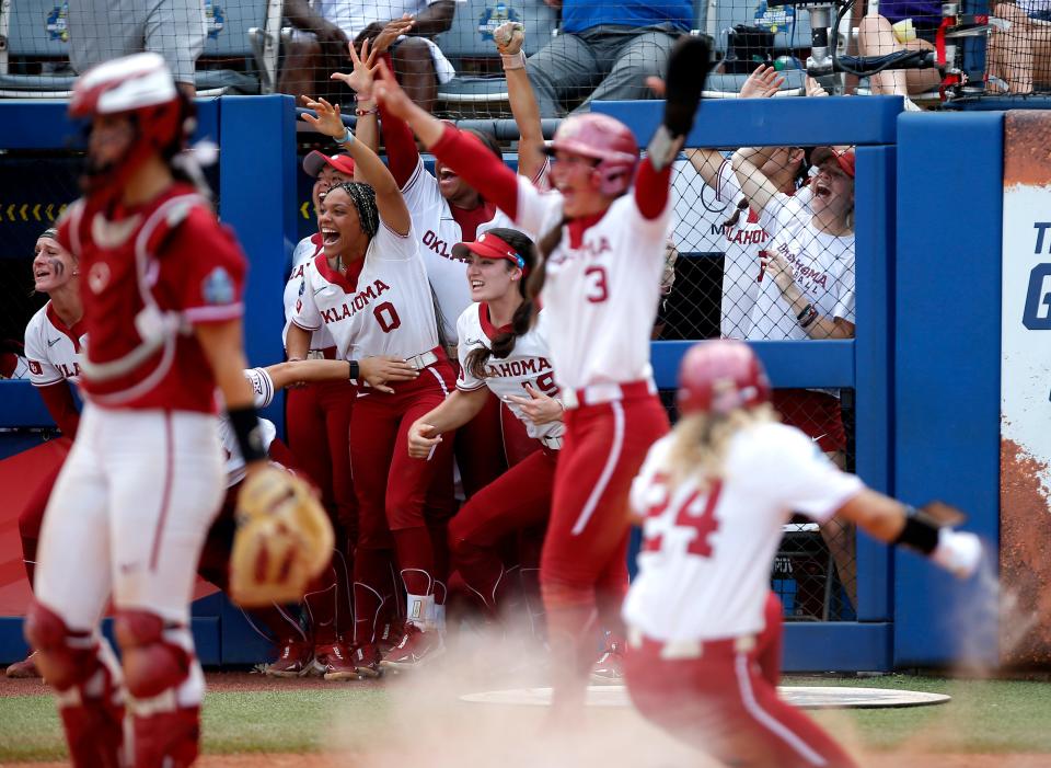Oklahoma celebrates Tiare Jennings' two run double in the ninth inning during a softball game between the Oklahoma Sooners and Stanford in the Women's College World Series at USA Softball Hall of Fame Stadium in  in Oklahoma City, Monday, June, 5, 2023. 
