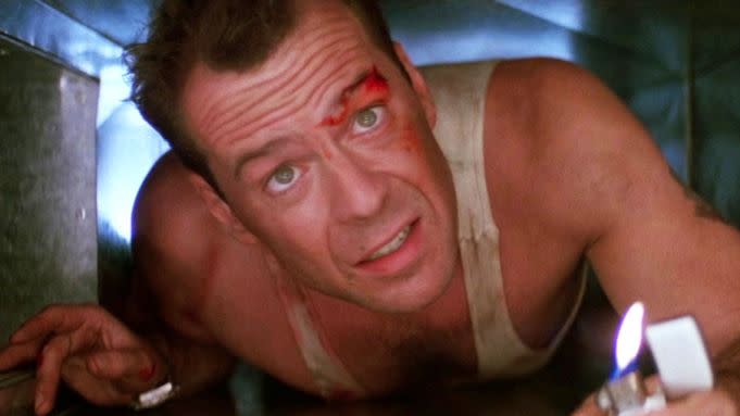 A still from the movie Die Hard showing Bruce Willis as John McClane, a New York City police detective, in an air vent.