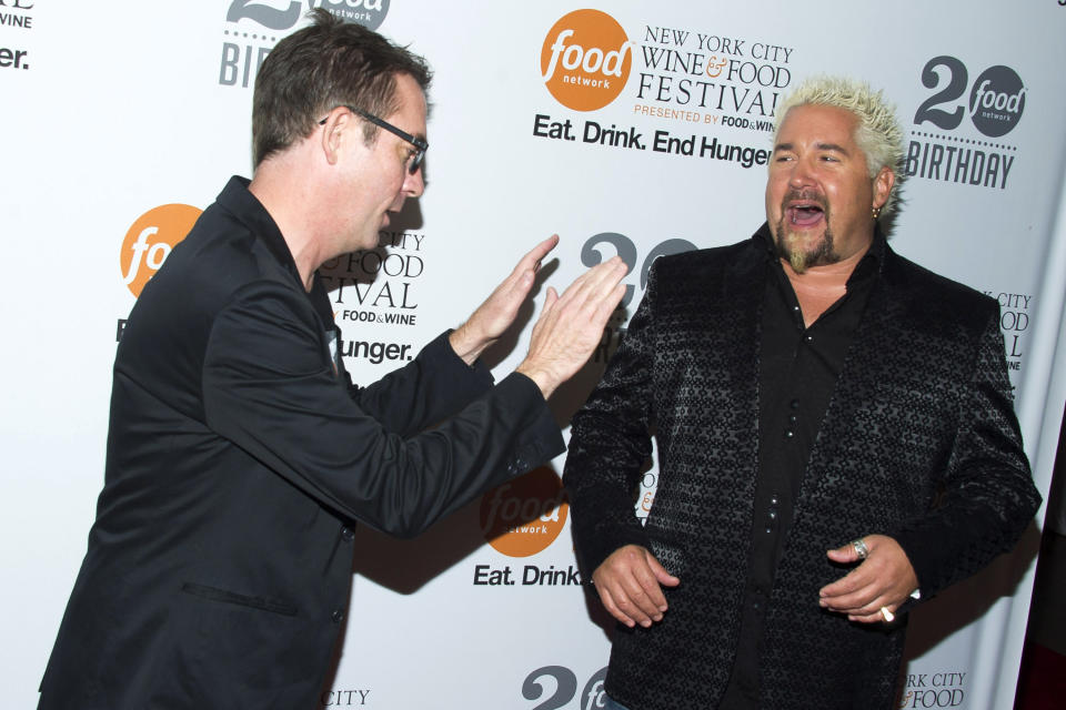 Ted Allen, left, and Guy Fieri attend the Food Network's 20th birthday party on Thursday, Oct. 17, 2013, in New York. (Photo by Charles Sykes/Invision/AP)