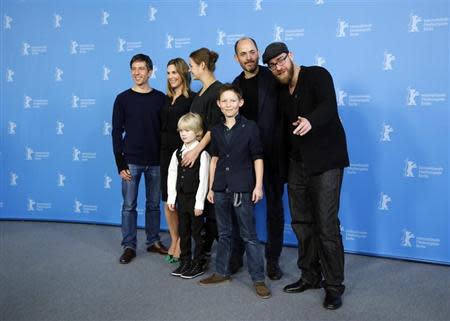 Cast members Georg Arms and Ivo Pietzcker (front, L-R), cameraman Jens Harant, Nele Mueller-Stofen, Luise Heyer, director Edward Berger and producer Jan Krueger (top, L-R) attend a photocall to promote the movie "Jack" during the 64th Berlinale International Film Festival in Berlin February 7, 2014. REUTERS/Thomas Peter