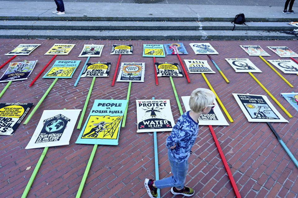 Signs are placed on a sidewalk as demonstrators prepare to march in opposition to the APEC Summit Sunday, Nov. 12, 2023 in San Francisco. Hundreds of business executives, foreign press and world leaders will descend on San Francisco for the highly anticipated global trade summit. (AP Photo/ Noah Berger)