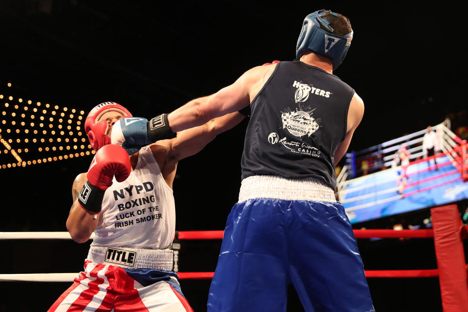 <p>Paul Altimore, left extends his reach into the face of Luis Rodriguez during the NYPD Boxing Championships at the Theater at Madison Square Garden on June 8, 2017.(Photo: Gordon Donovan/Yahoo News) </p>