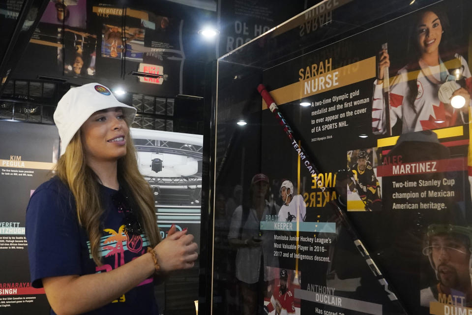 Sarah Nurse, a Canadian hockey player and two-time Olympic gold medalist, views a display of herself at the United for Hockey Mobile Museum, Thursday, Feb. 2, 2023, in Fort Lauderdale, Fla. The museum highlights the hockey careers of underrepresented communities and women. (AP Photo/Marta Lavandier)