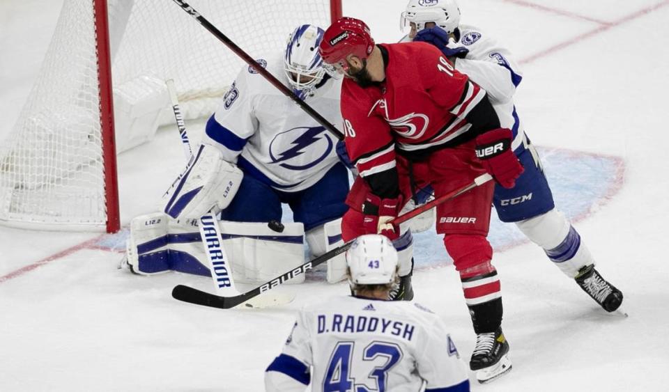 Tampa Bay goalie Maxime Lagace (33) deflects a shot by Carolina Hurricanes’ Vincent Trocheck (16) during the first period of their NHL exhibition game on Tuesday, September 28, 2021 at PNC Arena in Raleigh, N.C.