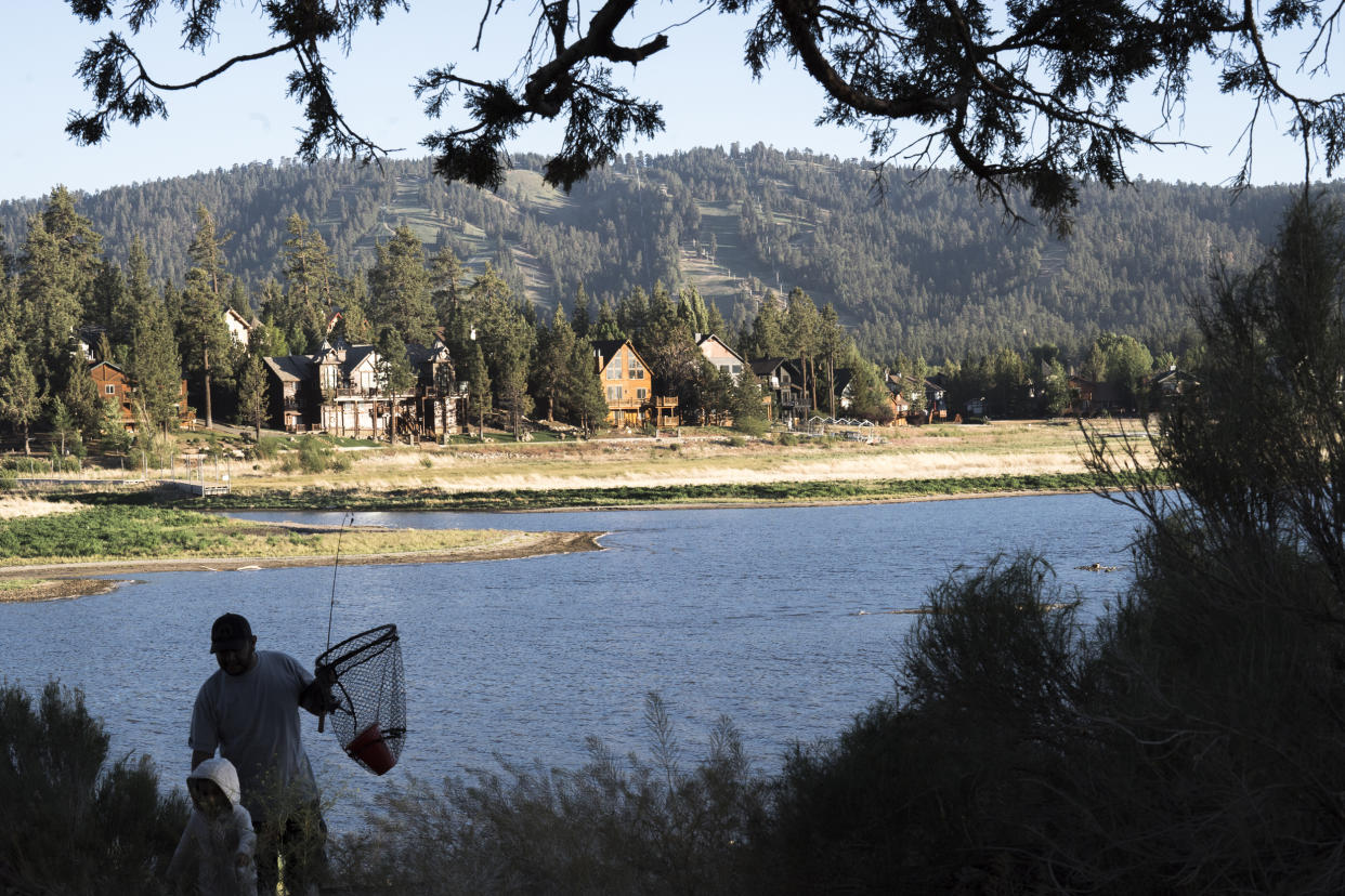 Image:  A father and child return to their car after fishing on Big Bear Lake on June 6, 2022. (Gabriella Angotti-Jones for NBC News)