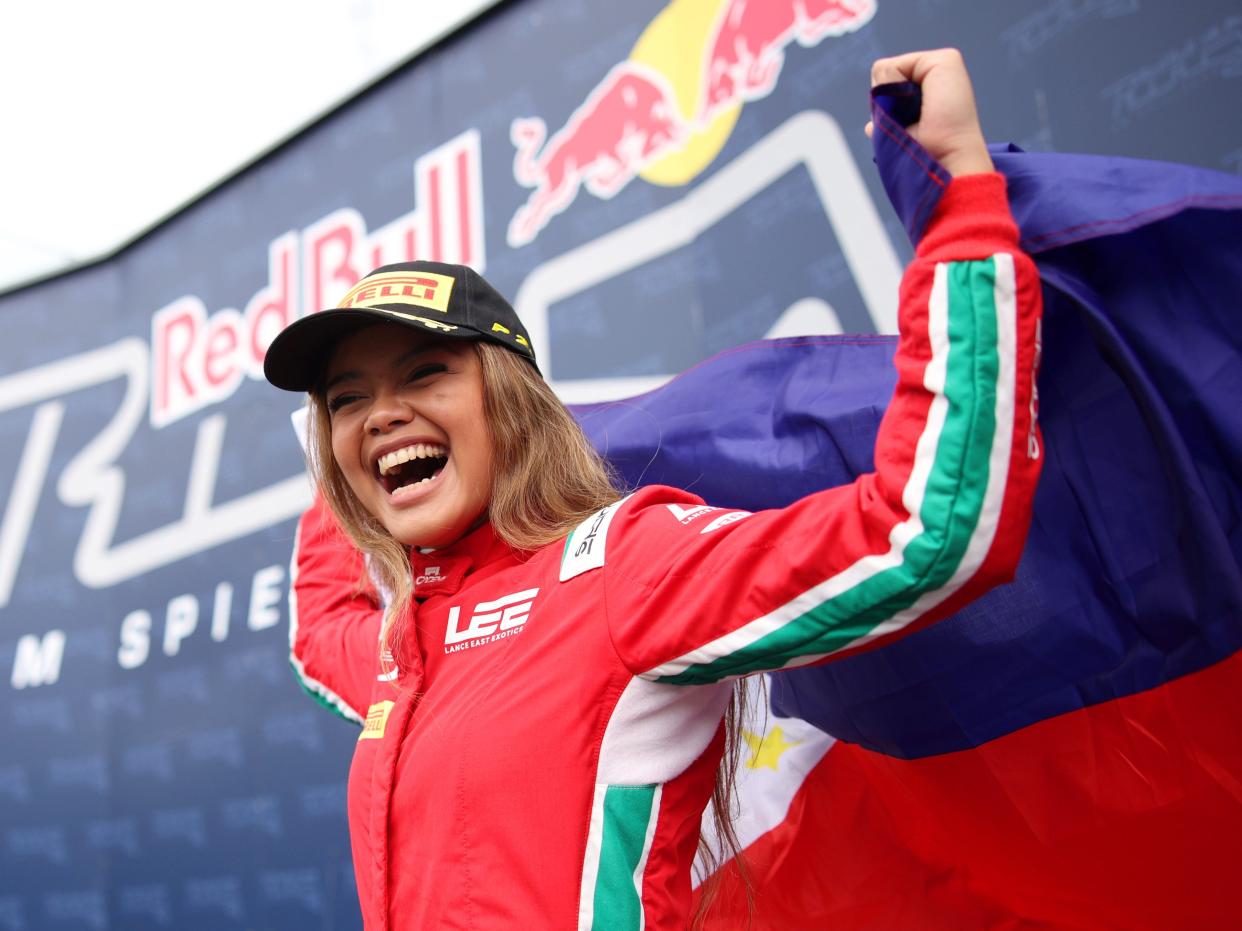 Bianca Bustamante celebrates on the podium following the F1 Academy Series.