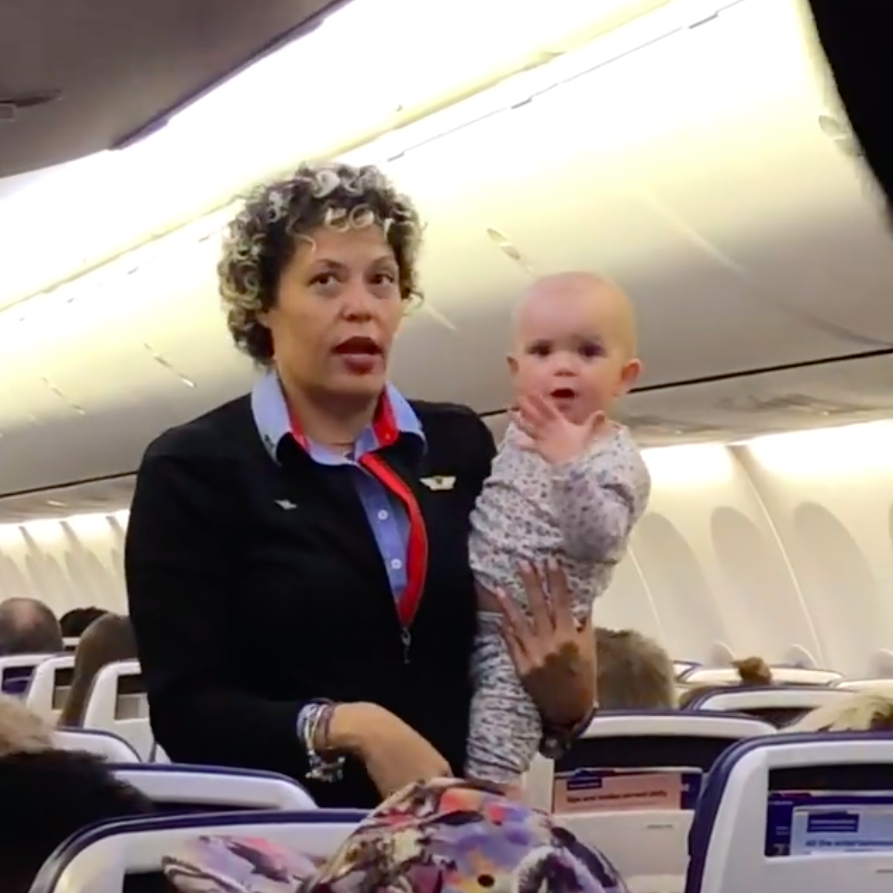 A Southwest flight attendant named Jessica gave an overwhelmed mom a rest by holding her toddler on a recent flight. (Photo: Courtesy of Facebook/Savannah Blum)