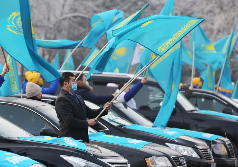 Supporters of the Nur Otan ruling party wave national flags during a pre-election rally in Almaty