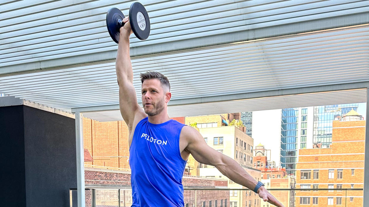  Andy Speer performing a dumbbell overhead press. 