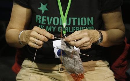 File photo of a member of Germany's environmental party Die Gruenen (The Greens) knitting a sock during a party congress in Berlin April 27, 2013. REUTERS/Tobias Schwarz/Files