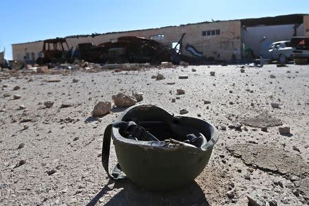 A helmet belonging to a Islamic State militant is seen on the ground at the 121 Regiment base after Fighters from the Democratic Forces of Syria took control of the base in the town of al-Melabiyyah, south of Hasaka city, Syria November 24, 2015. REUTERS/Rodi Said