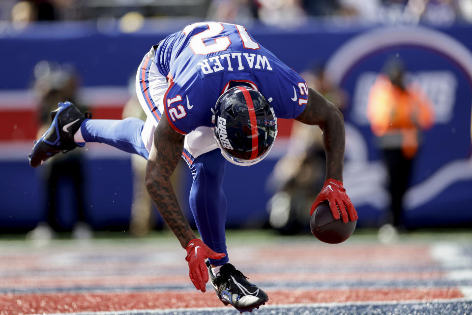 New York Giants tight end Darren Waller (12) comes down with a touchdown catch against the Washington Commanders during the second quarter of an NFL football game, Sunday, Oct. 22, 2023, in East Rutherford, N.J. (AP Photo/Adam Hunger)