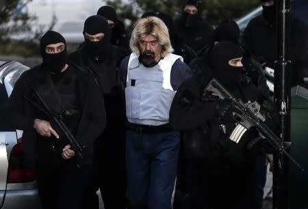 Greek fugitive Christodoulos Xiros is escorted by anti-terrorism police officers to the prosecutor in Athens January 4, 2015. REUTERS/Alkis Konstantinidis