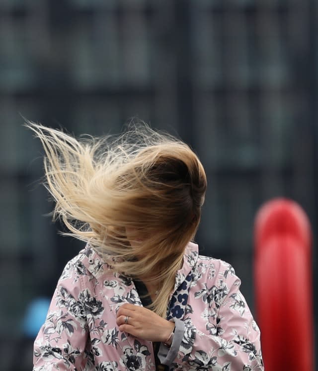 The wind catches a woman’s hair in London as Storm Francis hit the UK on August 25