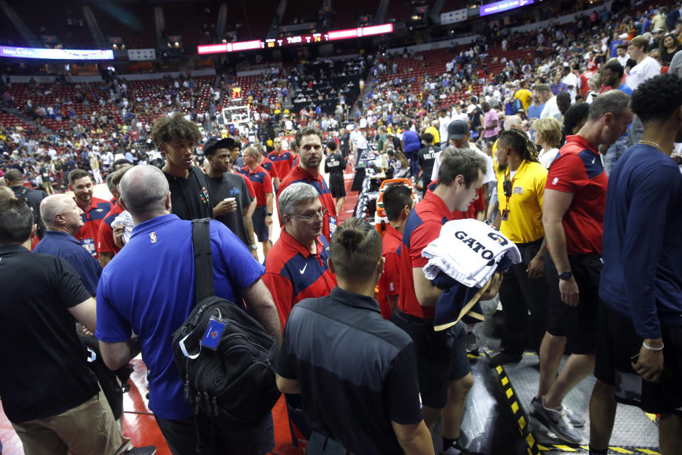 Players and staff leave the court after an earthquake during an NBA summer league basketball game between the New York Knicks and the New Orleans Pelicans on Friday, July 5, 2019, in Las Vegas. (AP Photo/Steve Marcus)