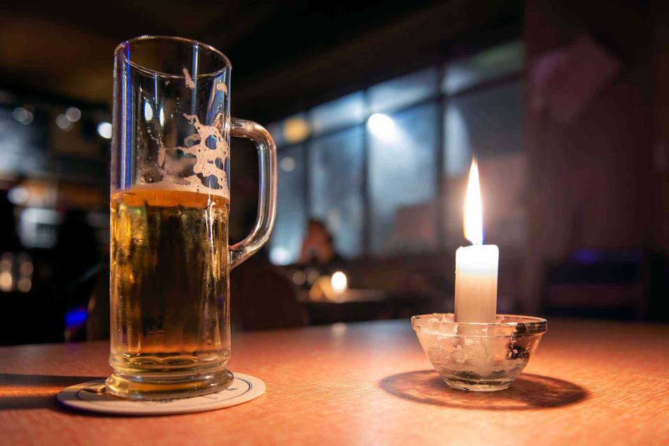 <p>Renolto / Getty Images</p> A beer and a candle light