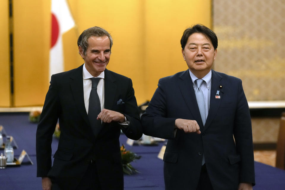 Director-General of the International Atomic Energy Agency (IAEA) Rafael Grossi, left, and Japanese Foreign Minister Yoshimasa Hayashi pose for a photo before their talk at the Iikura guesthouse in Tokyo, Thursday, May 19, 2022. (AP Photo/Hiro Komae)