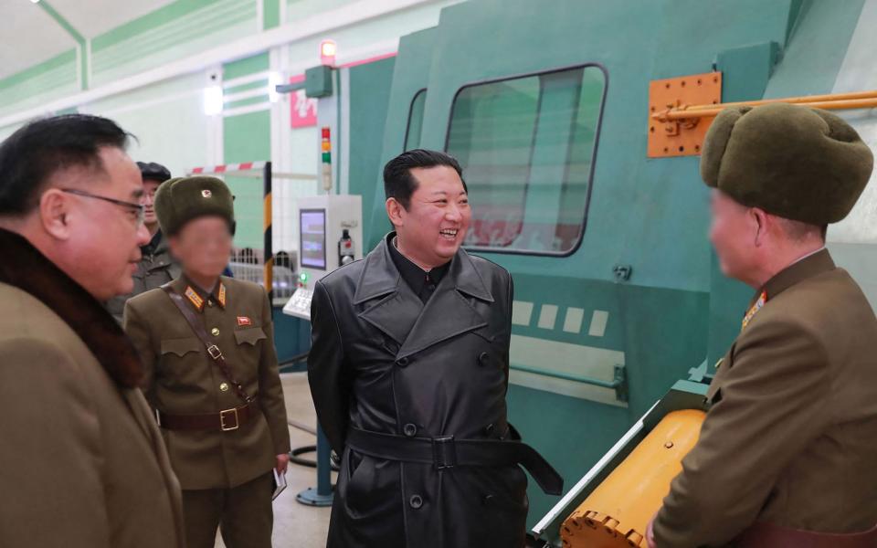 This undated picture released from North Korea's official Korean Central News Agency (KCNA) on January 28, 2022 shows North Korean leader Kim Jong Un (C) inspecting a munitions factory producing a major weapon system at an undisclosed location. (Photo by various sources / AFP) / - South Korea OUT / - AFP PHOTO/KCNA VIA KNS