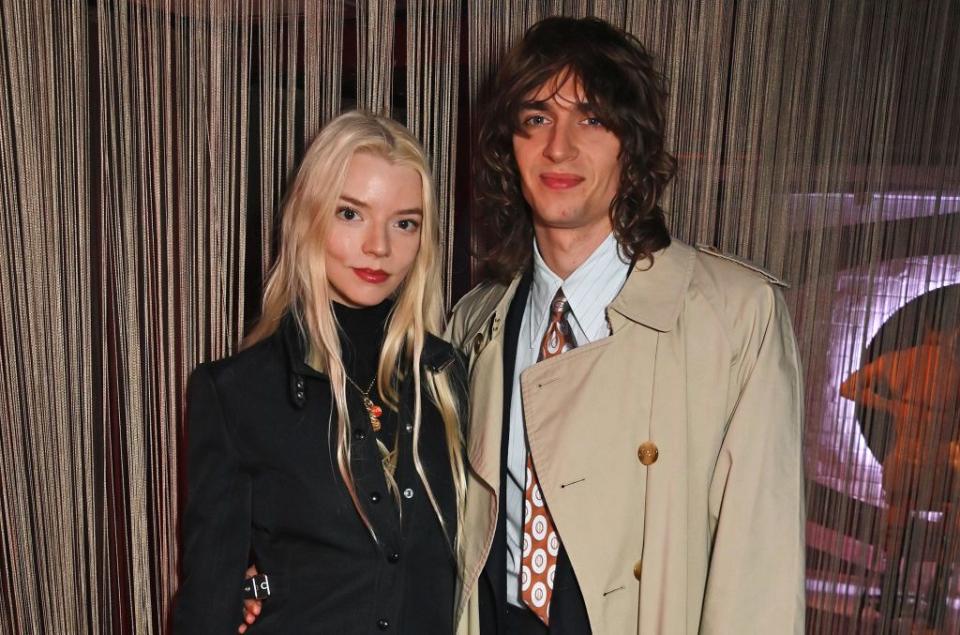 anya taylor joy and husband malcolm mcrae standing next to each other and smiling for a photo