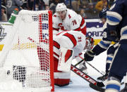 Columbus Blue Jackets forward Boone Jenner, right, scores past Carolina Hurricanes goalie Frederik Andersen, center, and defenseman Brady Skjei during the second period of an NHL hockey game in Columbus, Ohio, Saturday, Oct. 23, 2021. (AP Photo/Paul Vernon)