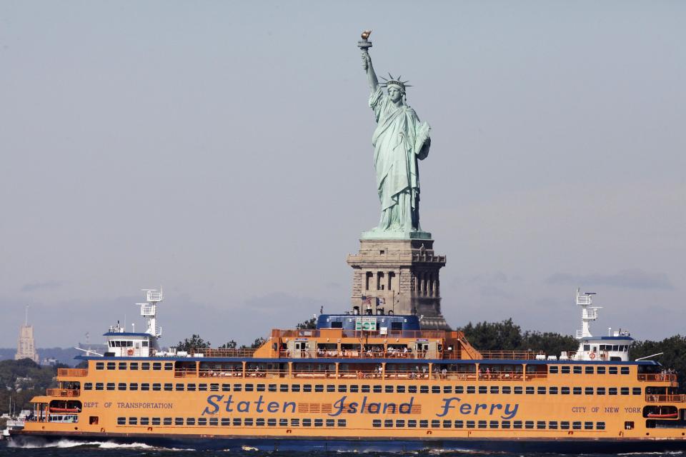 FILE - In this Oct. 1, 2012 file photo, the Staten Island Ferry passes the Statue of Liberty as it crosses New York Harbor. The Statue of Liberty, which has been closed to visitors since Superstorm Sandy, is scheduled to reopen for tours July Fourth, when Statue Cruises resumes departures for Liberty Island from Lower Manhattan. For tourists who want a photo of the famous statue without visiting the island, there are many options and vantage points, including rides on the free Staten Island Ferry. (AP Photo/Mark Lennihan, file)