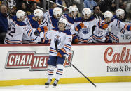 Edmonton Oilers right wing Kailer Yamamoto (56) is greeted by his teammates after scoring on Pittsburgh Penguins goalie Tristan Jarry during the second period of an NHL hockey game, Thursday, Feb. 23, 2023, in Pittsburgh. (AP Photo/Philip G. Pavely)