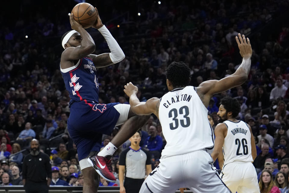 Philadelphia 76ers' Paul Reed, left, goes up for a shot against Brooklyn Nets' Nic Claxton during the first half of an NBA basketball game, Saturday, Feb. 3, 2024, in Philadelphia. (AP Photo/Matt Slocum)