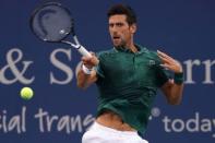 Aug 16, 2018; Mason, OH, USA; Novak Djokovic (SRB) returns a shot against Grigor Dimitrov (BUL) in the Western and Southern tennis open at Lindner Family Tennis Center. Aaron Doster-USA TODAY Sports