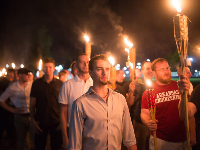 Neo Nazis, Alt-Right, and White Supremacists take part a the night before the 'Unite the Right' rally in Charlottesville, VA, white supremacists march with tiki torchs through the University of Virginia campus. (Photo by Zach D Roberts/NurPhoto via Getty Images)