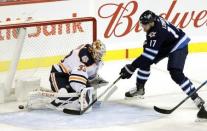 Oct 16, 2018; Winnipeg, Manitoba, CAN; Winnipeg Jets center Adam Lowry (17) scores on Edmonton Oilers goaltender Cam Talbot (33) in the first period at Bell MTS Place. Mandatory Credit: James Carey Lauder-USA TODAY Sports