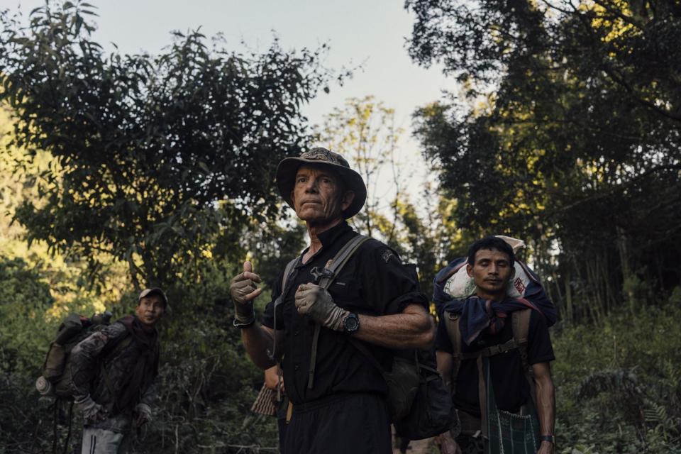 Eubank pauses on the trail with a ranger moments after a Burma Army mortar exploded on a nearby hill in Limerplaw in January.