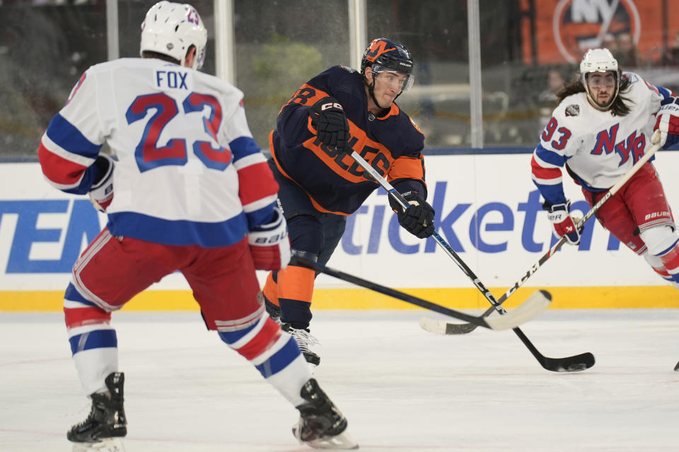 New York Islanders Pierre Engvall, center, shoots during the second period of an NHL Stadium Series hockey game against the New York Rangers in East Rutherford, N.J., Sunday, Feb. 18, 2024. (AP Photo/Seth Wenig)