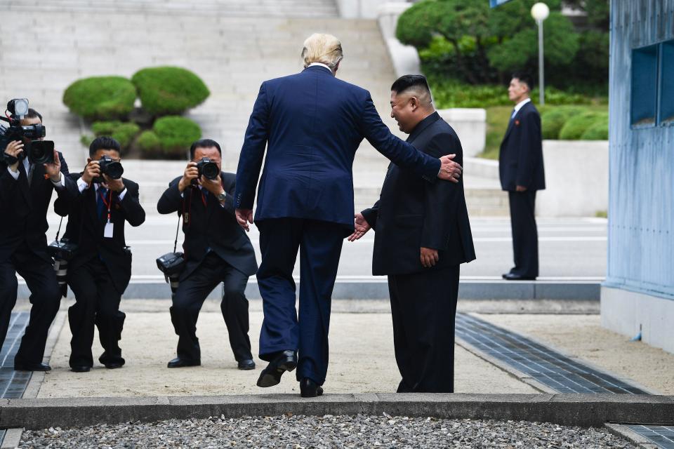  In this file photo taken on June 30, 2019, US President Donald Trump steps into the northern side of the Military Demarcation Line that divides North and South Korea, as North Korea's leader Kim Jong Un looks on, in the Joint Security Area (JSA) of Panmunjom in the Demilitarized zone (DMZ).  / Credit: BRENDAN SMIALOWSKI / Getty Images