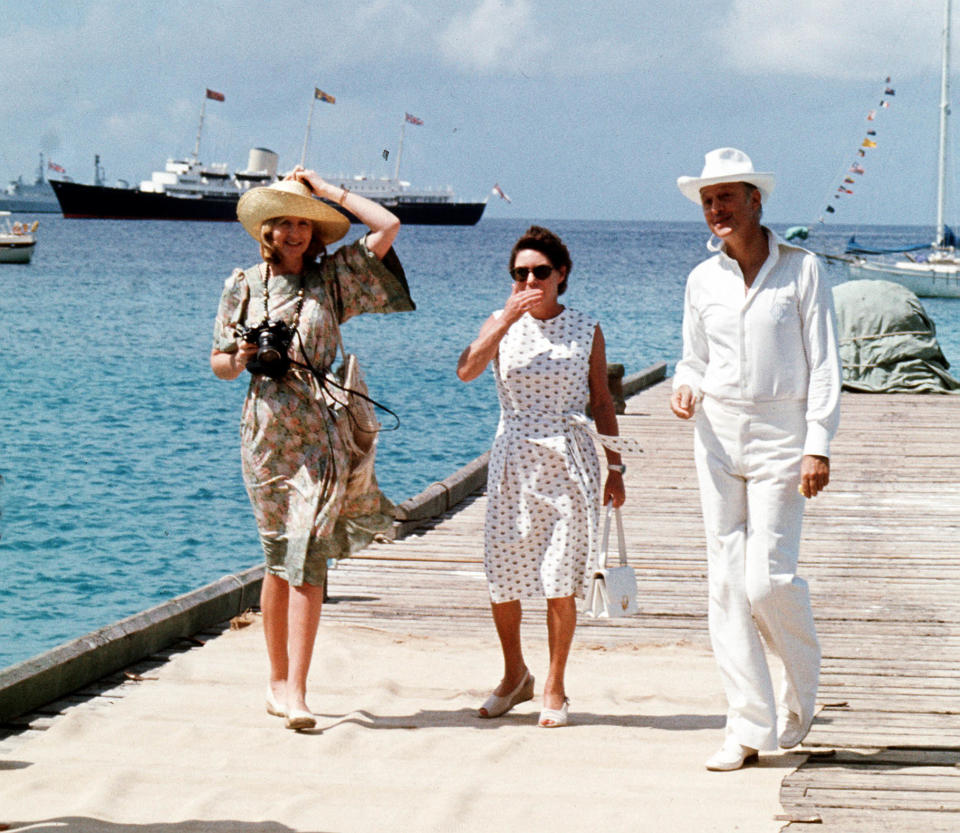 Mustique is a favourite with Princess Margaret (centre), pictured here in 1977 with friends Lady Ann Tennant and Colin Tennant waiting on the jetty on the Caribbean island of Mustique to greet the Queen (Picture: PA)