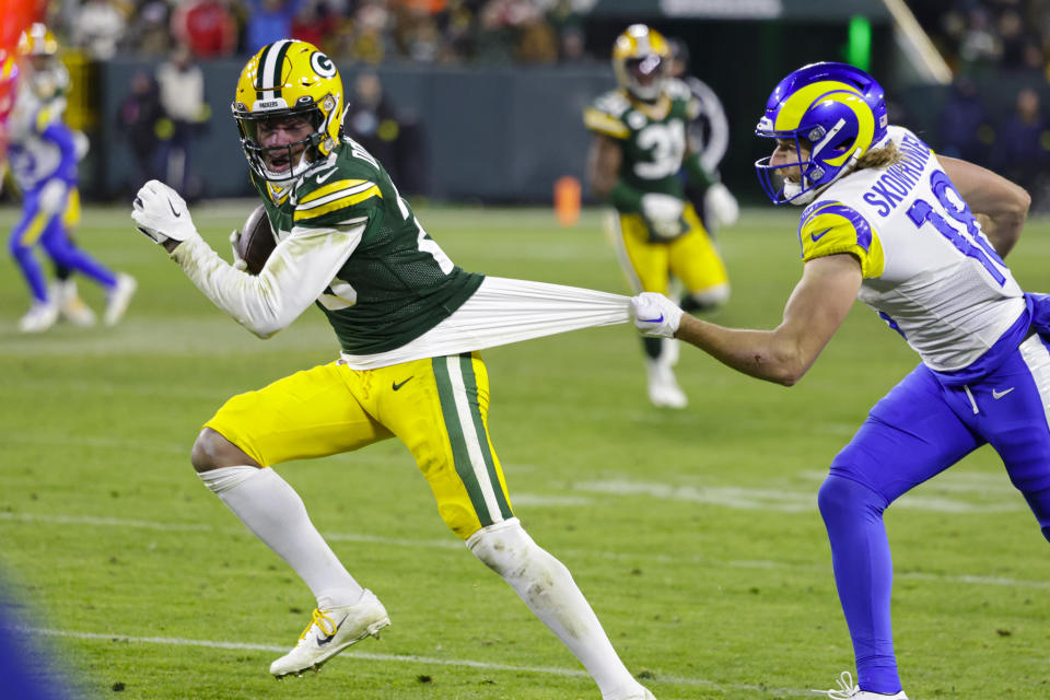 Los Angeles Rams wide receiver Ben Skowronek (18) tries to tackle Green Bay Packers cornerback Rasul Douglas (29) after an interception in the second half of an NFL football game in Green Bay, Wis. Monday, Dec. 19, 2022. (AP Photo/Matt Ludtke)