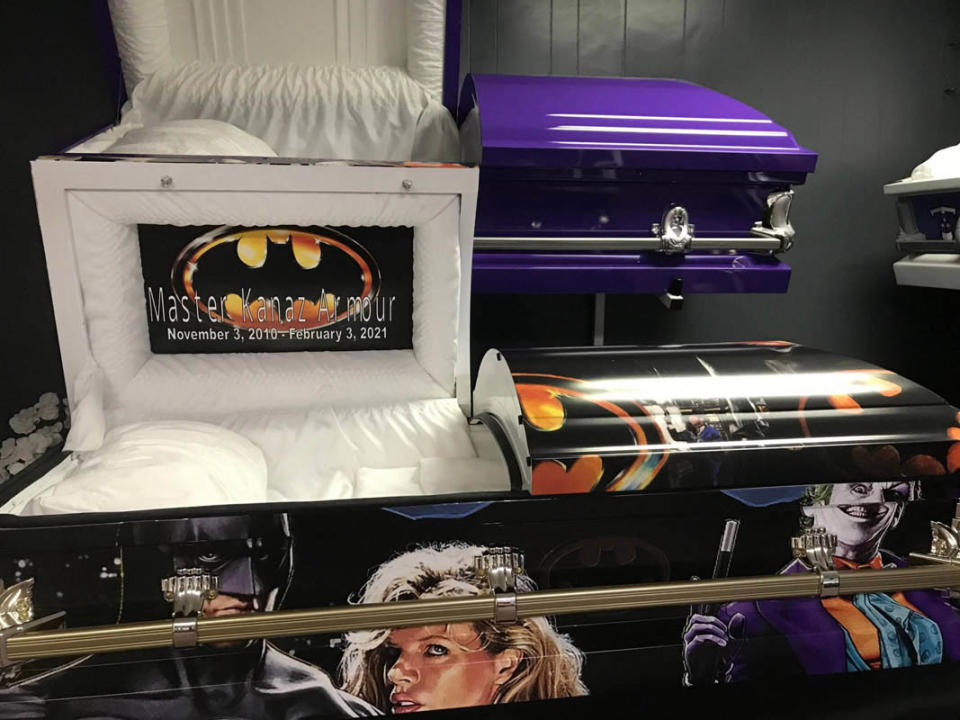 a batman themed casket with the top portion open 