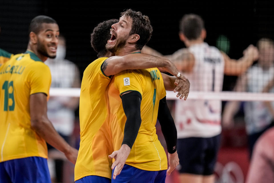 Brazil's Bruno Mossa Rezende celebrates his team victory against United States during a men's volleyball preliminary round pool B match between Brazil and United States at the 2020 Summer Olympics, Friday, July 30, 2021, in Tokyo, Japan. (AP Photo/Manu Fernandez)