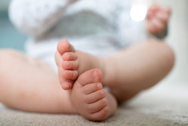 Baby sits on mat