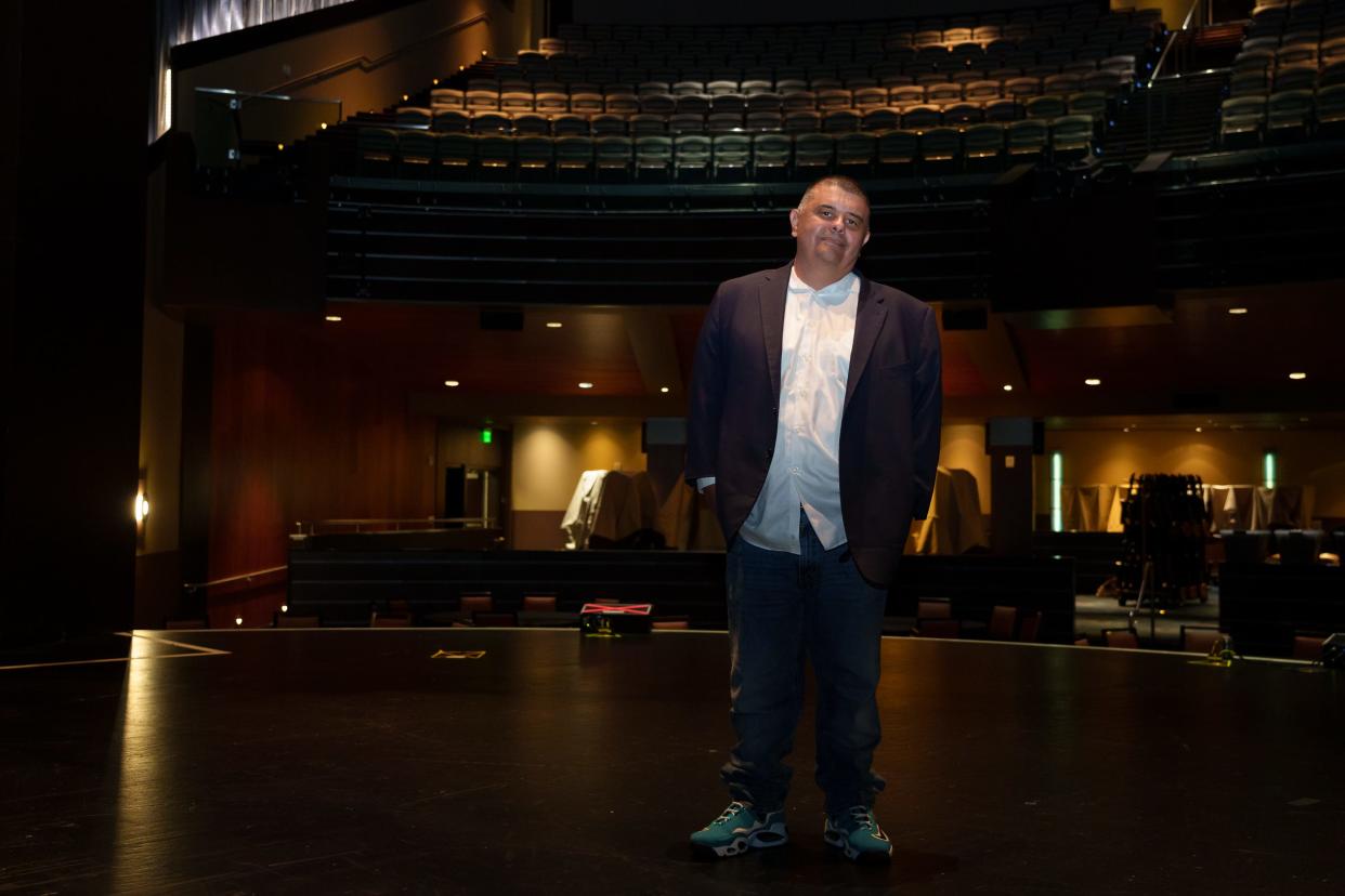 Gila River Indian Community Defense Services Office director and playwright Claude Jackson Jr. stands for a portrait on a stage at Wild Horse Pass Casino on Dec. 29, 2022, in Chandler, Ariz.