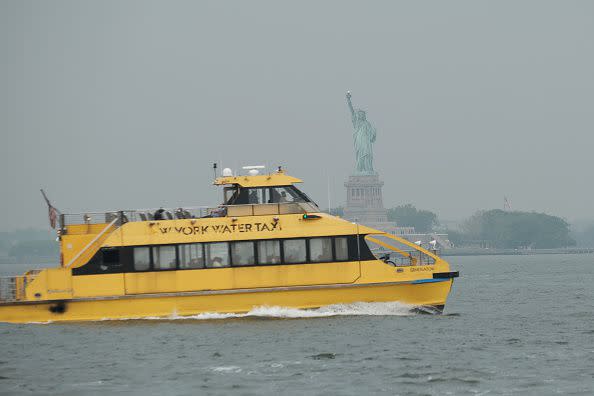 NEW YORK, NEW YORK - JUNE 06: A water taxi moves past the Statue of Liberty on a hazy morning resulting from Canadian wildfires on June 06, 2023 in New York City. Over 100 wildfires are burning in the Canadian province of Nova Scotia and Quebec causing air quality health alerts for New York State and parts of New England.  (Photo by Spencer Platt/Getty Images)