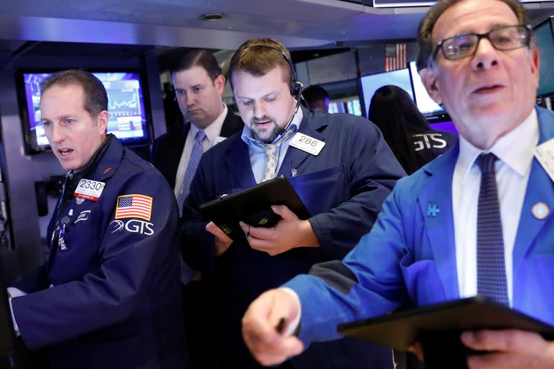 Traders work on the floor of the NYSE in New York