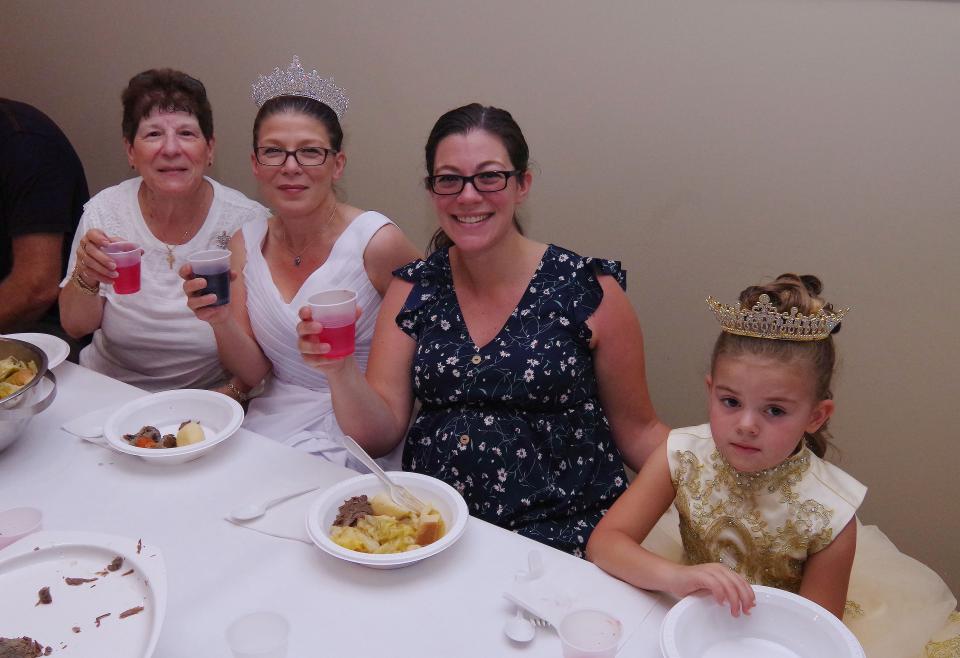 Four generations of a family in Taunton enjoy the 88th Holy Ghost Feast on Sunday, July 10, 2022. From left are Lucy Rebello, the great grandmother; Kelly Terrasi, Queen for the Holy Ghost Feast ceremony, the grandmother, Courtney Terrasi, the granddaughter, and Mia Fay, 6, the great-granddaughter, all from Taunton.