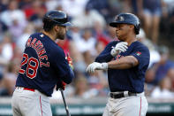 Boston Red Sox's Rafael Devers, right, celebrates with J.D. Martinez after hitting a solo home run against the Cleveland Guardians during the third inning of a baseball game Friday, June 24, 2022, in Cleveland. (AP Photo/Ron Schwane)