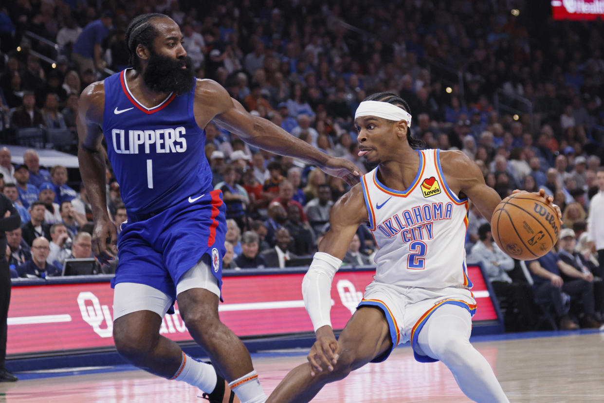 Oklahoma City Thunder guard Shai Gilgeous-Alexander (2) drives against Los Angeles Clippers guard James Harden (1) during the first half of an NBA basketball game, Thursday, Feb. 22, 2024, in Oklahoma City. (AP Photo/Nate Billings)